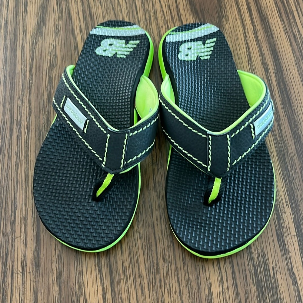 Kids New Balance flip flops, never worn (except to try on). Size M (2.5)